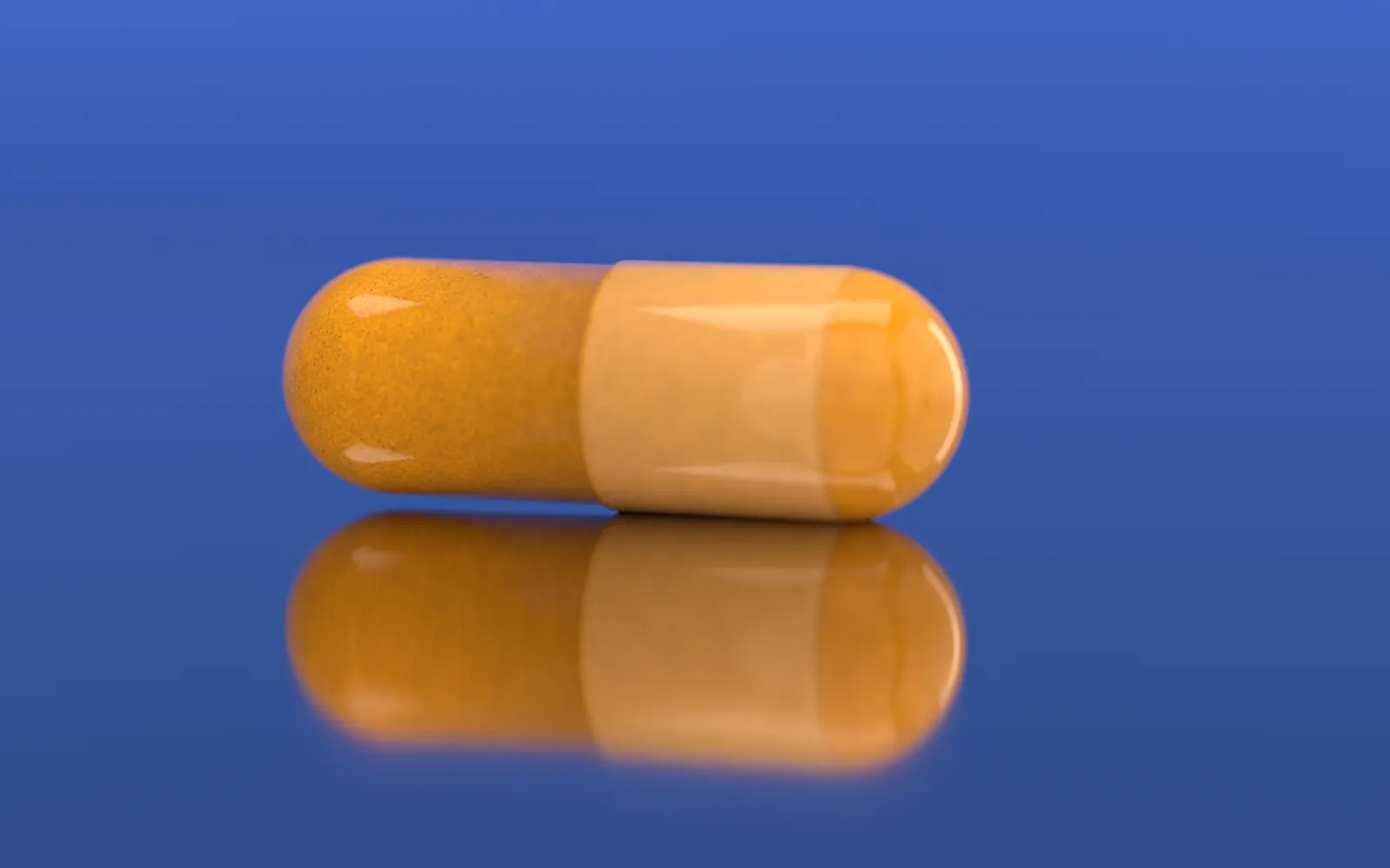 Lower, along the steel: the capsule and its reflection, the paler band where the cap overlaps the body.