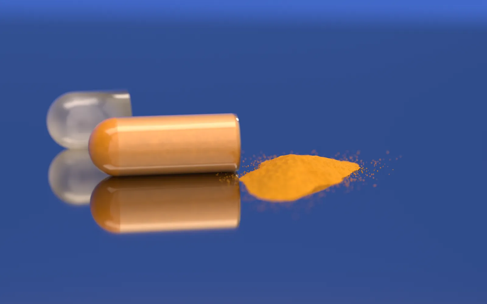 An opened capsule, its empty cap beside it, and its own small heap of turmeric root powder.